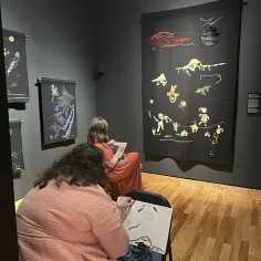 Two women drawing at the rooms