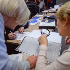 two women looking at an archival document