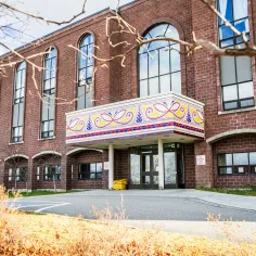Photo caption: Fine Arts Building, Grenfell Campus. Balcony artwork: Melissa Tremblett, caribou coat continuum, 2024. Photo: Lori-Lee Pike 